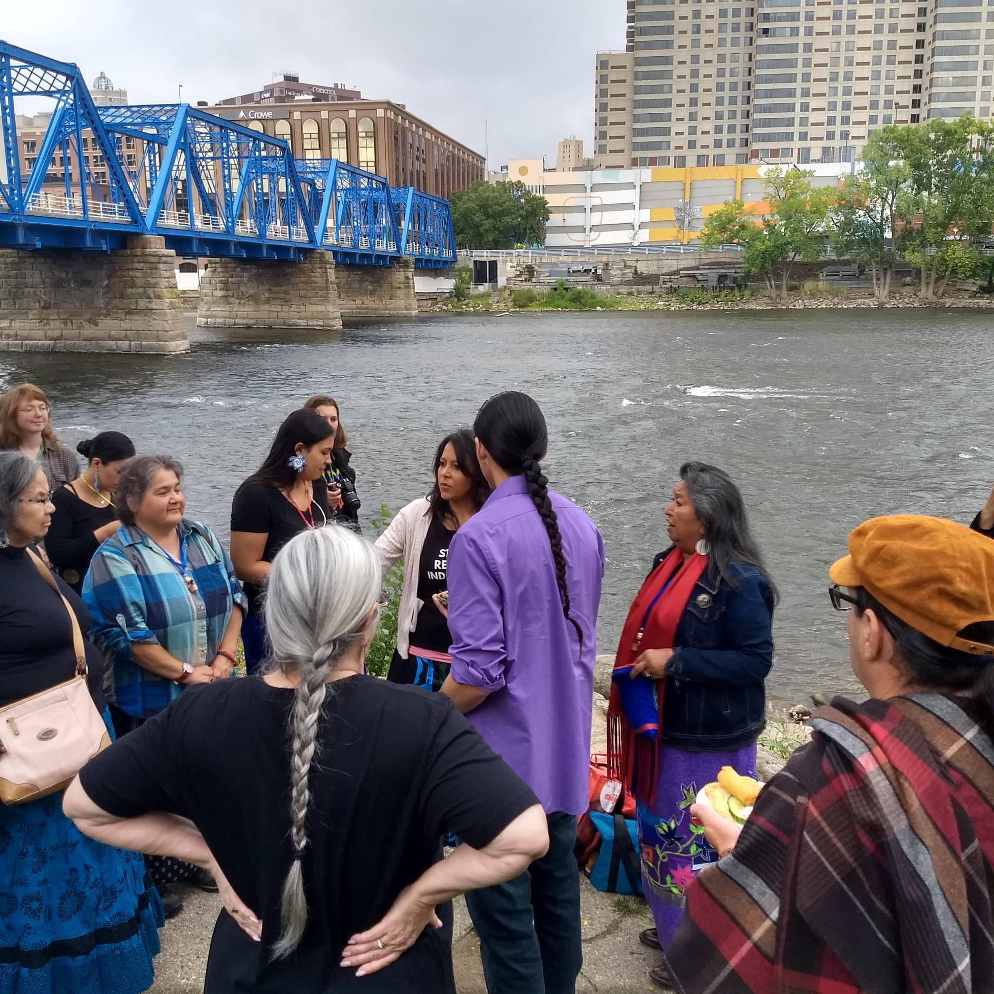 gathering of Native individuals at shore of Grand River in Grand Rapids, MI
